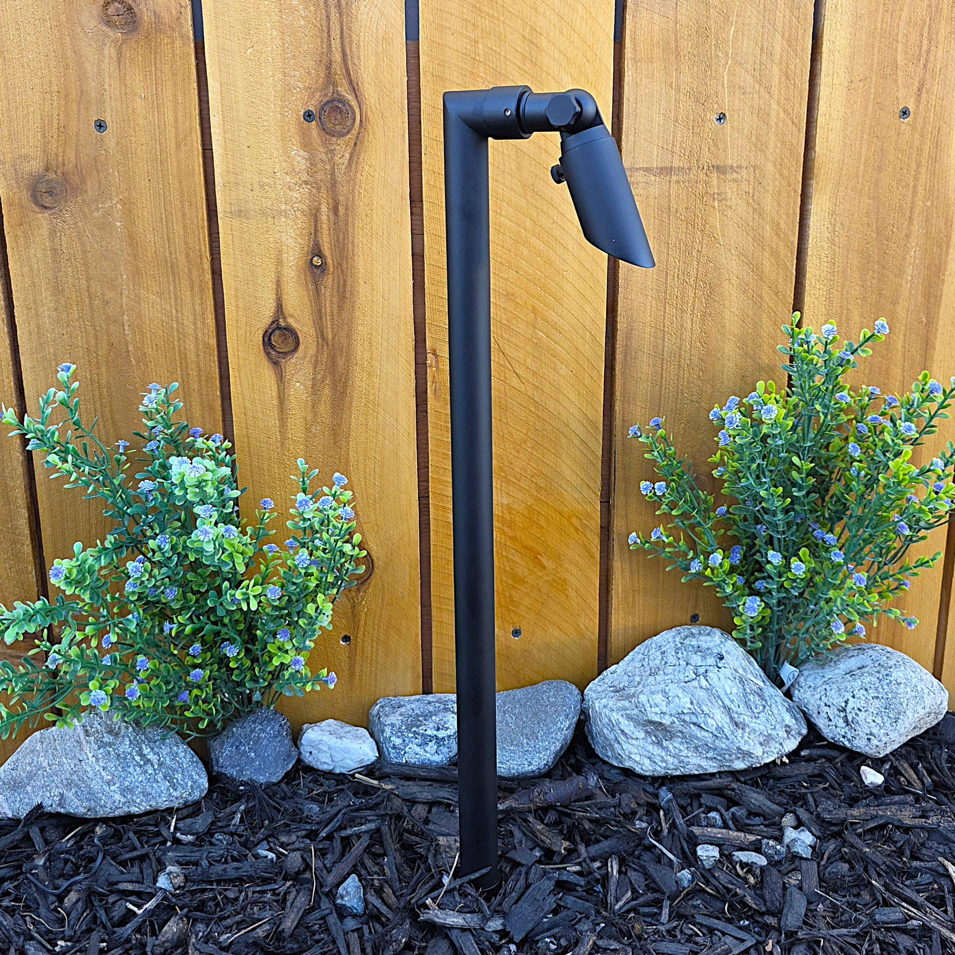 Zone Solid Brass Directional Path Light on a stake, outdoor landscape lighting beside a wooden fence.