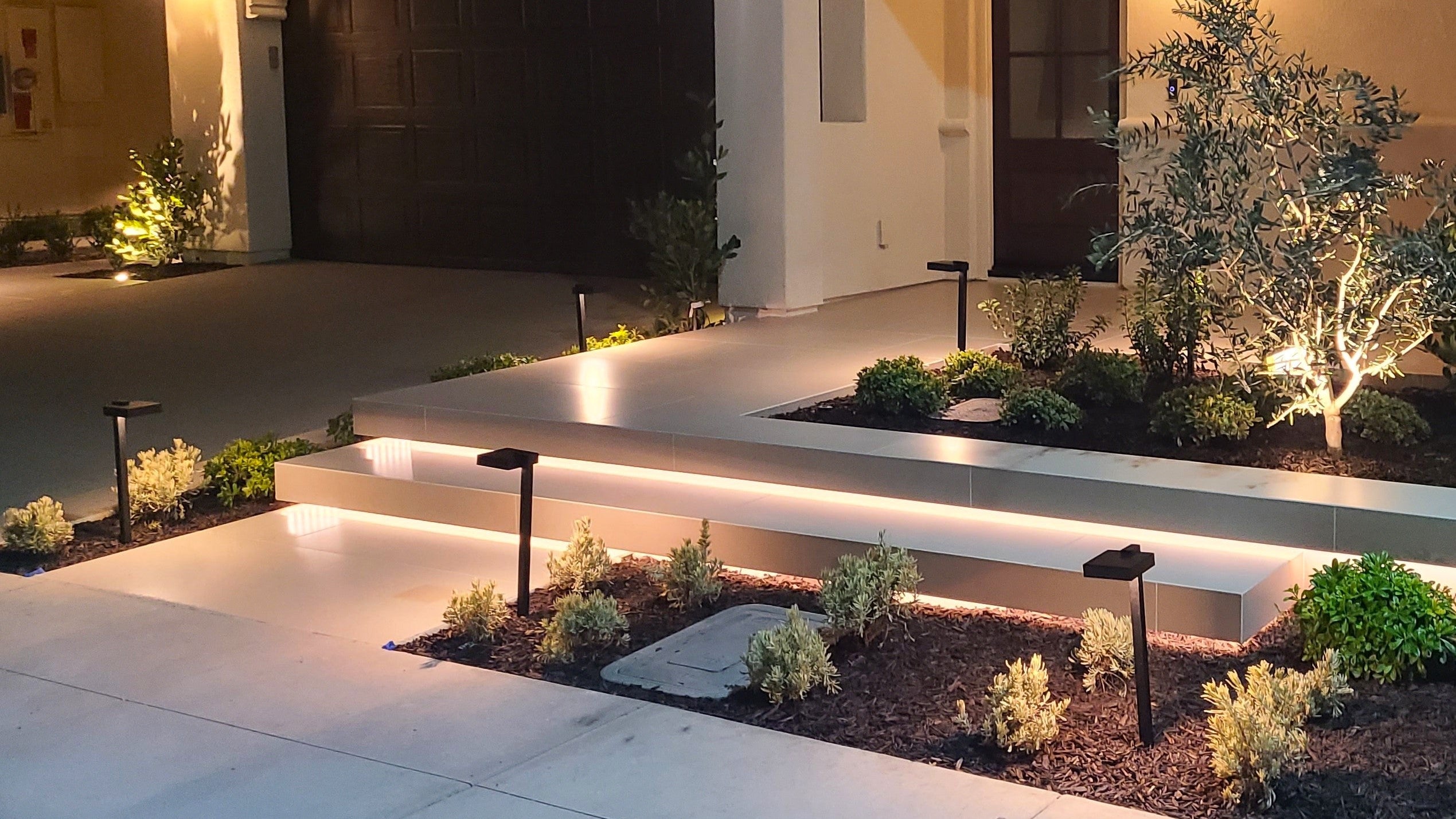 Modern outdoor patio with lighting and plants in a residential setting
