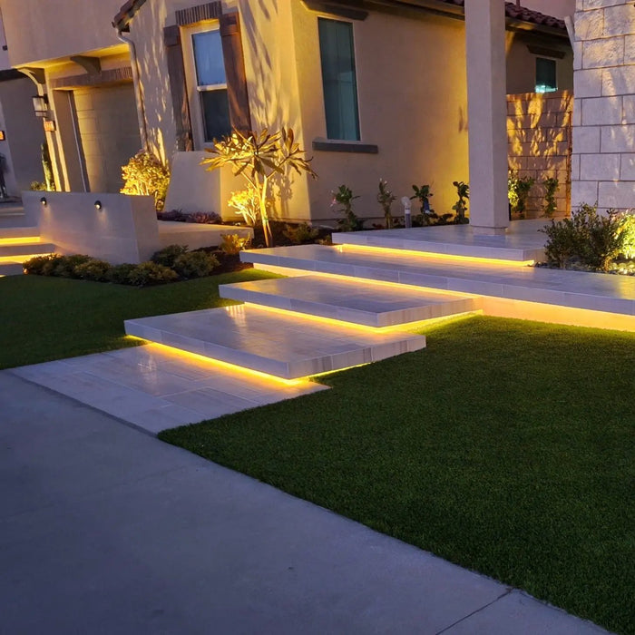 Warm white LED COB outdoor strip lights under illuminated stair steps, IP67 weatherproof landscape lighting.